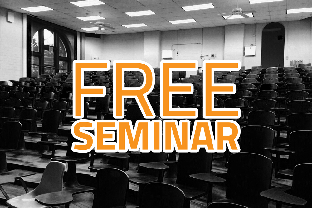 Picture of a seated auditorium with type written across the front saying, "free seminar"