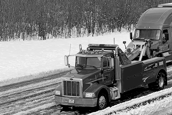 Tow truck driving in snow