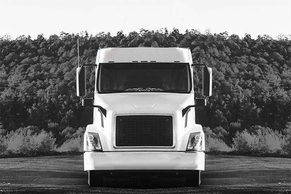 white-volvo-semi-truck-on-side-of-road